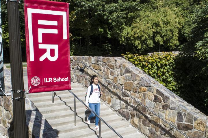 A student walking down the steps outside Ives Hall